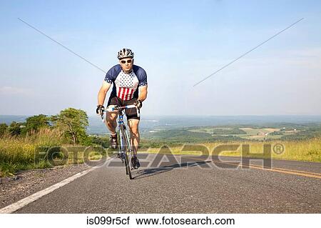 Man cycling on open road View Large Photo Image Stock Image - Man cycling on open road. Fotosearch