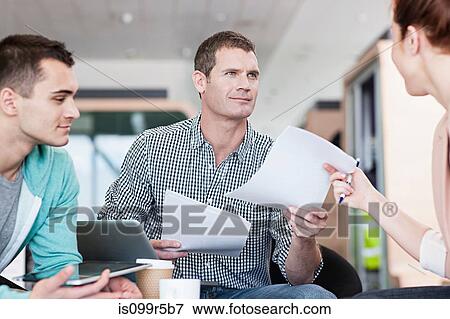 Stock Photo - Man giving woman document. Fotosearch