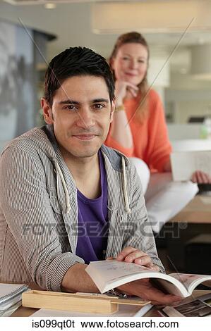 Man holding book, portrait View Large Photo Image Stock Photograph - Man holding book, portrait. Fotosearch