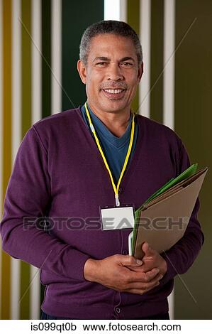 Man holding files, portrait View Large Photo Image Stock Image - Man holding files, portrait. Fotosearch