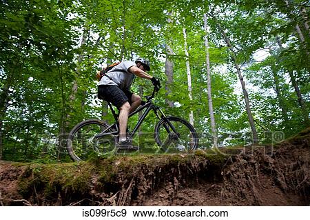 Man mountain biking on ledge View Large Photo Image Stock Photo - Man mountain biking on ledge. Fotosearch