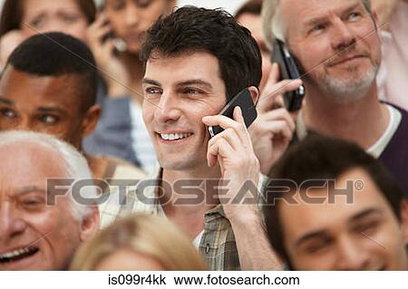 Man on cell phone with group of people View Large Photo Image Stock Image - Man on cell phone with group of people. Fotosearch