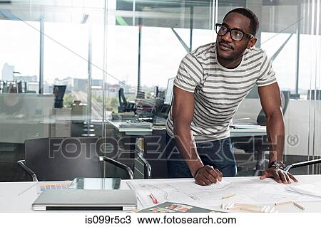 Stock Image - Man planning in office. Fotosearch