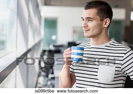 Stock Image - Man taking coffee break. Fotosearch