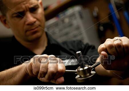 Man tightening bolt View Large Photo Image Picture - Man tightening bolt. Fotosearch