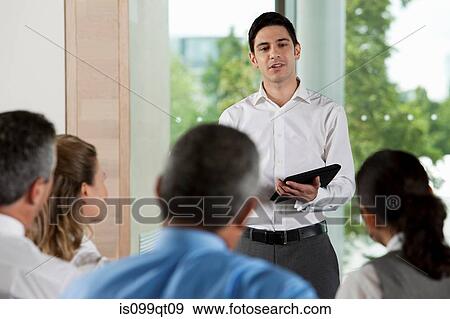 Stock Photo - Man using digital tablet in business meeting. Fotosearch