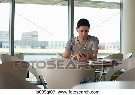Man using digital tablet in cafe View Large Photo Image Stock Photo - Man using digital tablet in cafe. Fotosearch