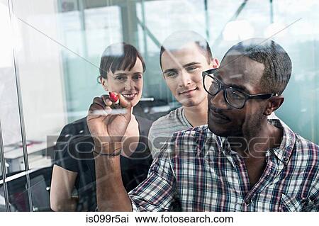 Stock Image - Man writing on glass. Fotosearch