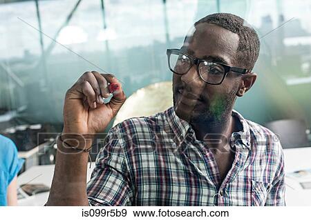 Stock Photo - Man writing on glass. Fotosearch