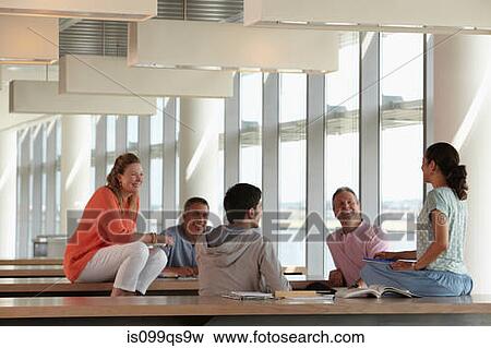Mature students in class, women sitting on desk View Large Photo Image Stock Photo - Mature students in class, women sitting on desk. Fotosearch
