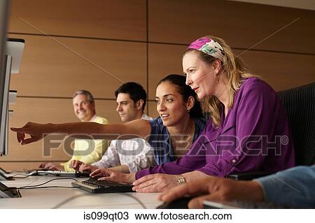 Stock Image - Mature students in computer class. Fotosearch