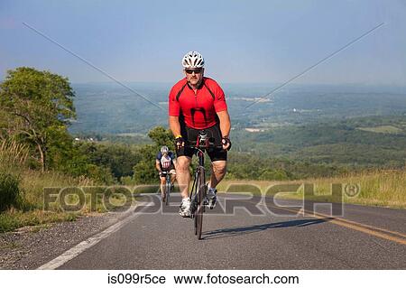 Men cycling on open road View Large Photo Image Stock Image - Men cycling on open road. Fotosearch