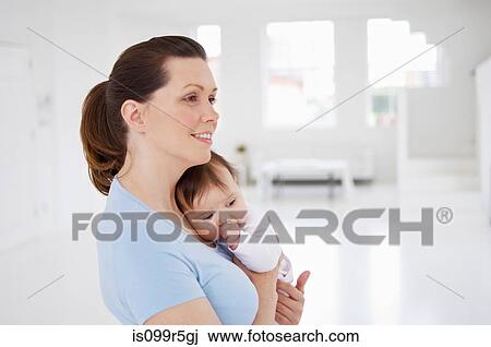Stock Image - Mother and baby daughter. Fotosearch