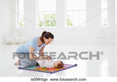 Mother and baby on play mat View Large Photo Image Picture - Mother and baby on play mat. Fotosearch