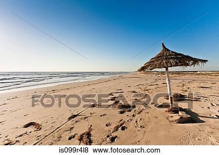 Parasol on beach on island of Djerba, Tunisia View Large Photo Image Stock Photo - Parasol on beach on island of Djerba, Tunisia. Fotosearch