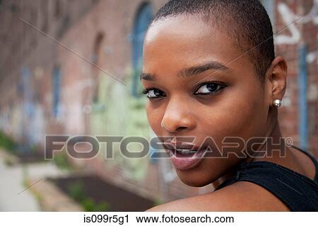 Portrait of a young woman with shaved head View Large Photo Image Stock Image - Portrait of a young woman with shaved head. Fotosearch