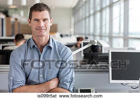 Stock Photograph - Portrait of man with arms folded. Fotosearch