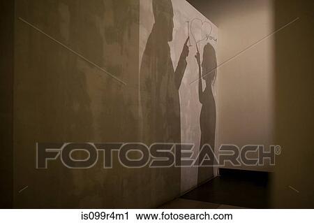 Shadows of couple and message of love on wall View Large Photo Image Stock Image - Shadows of couple and message of love on wall. Fotosearch