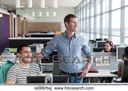 Stock Image - Two colleagues in office interior. Fotosearch
