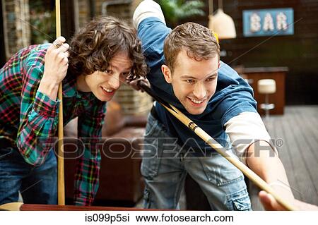 Two friends playing pool in bar View Large Photo Image Stock Image - Two friends playing pool in bar. Fotosearch