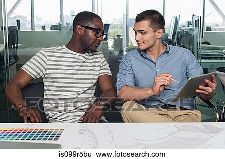 Stock Photograph - Two men with digital tablet. Fotosearch