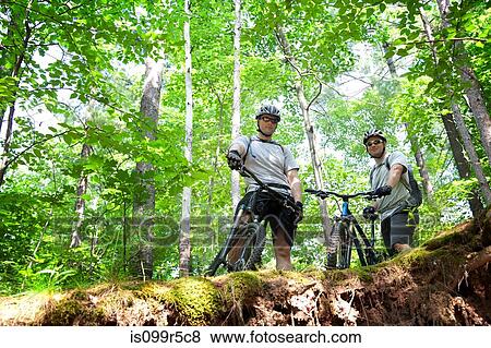 Two mountain bikers on ledge View Large Photo Image Stock Photo - Two mountain bikers on ledge. Fotosearch
