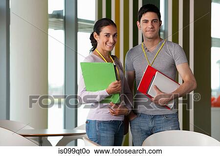 Two people holding files, portrait View Large Photo Image Picture - Two people holding files, portrait. Fotosearch