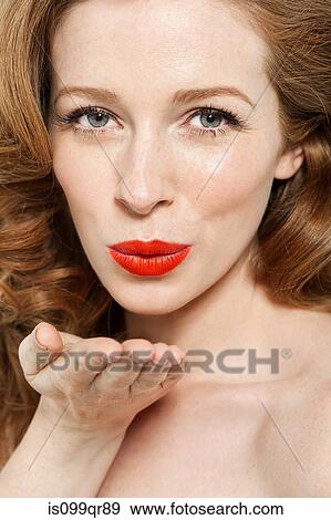 Woman blowing a kiss View Large Photo Image Stock Photo - Woman blowing a kiss. Fotosearch