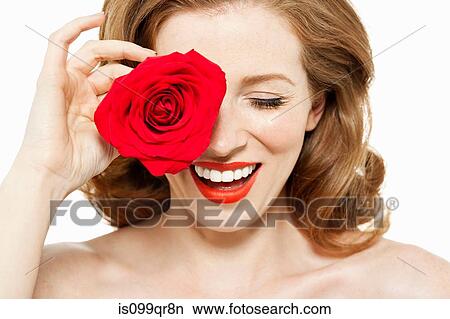 Woman covering eye with red rose View Large Photo Image Picture - Woman covering eye with red rose. Fotosearch