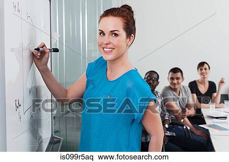 Stock Photography - Woman drawing graph on whiteboard. Fotosearch