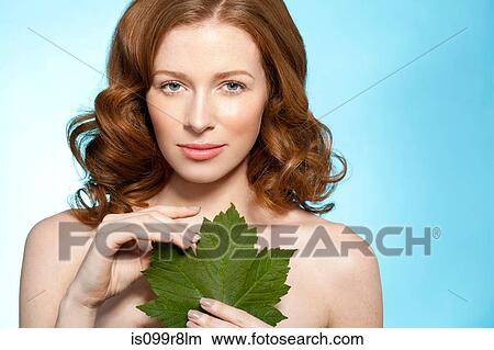 Woman holding green leaf View Large Photo Image Picture - Woman holding green leaf. Fotosearch