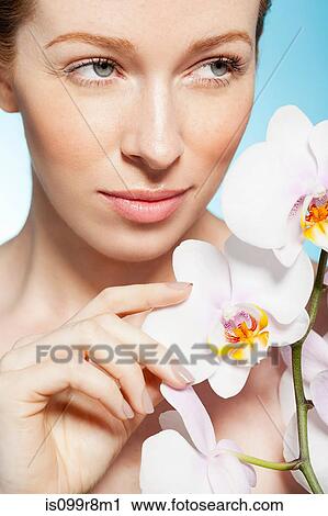 Woman holding orchids View Large Photo Image Stock Image - Woman holding orchids. Fotosearch