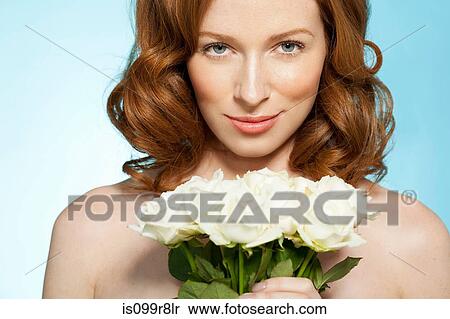 Woman holding roses, looking at camera View Large Photo Image Stock Photography - Woman holding roses, looking at camera. Fotosearch