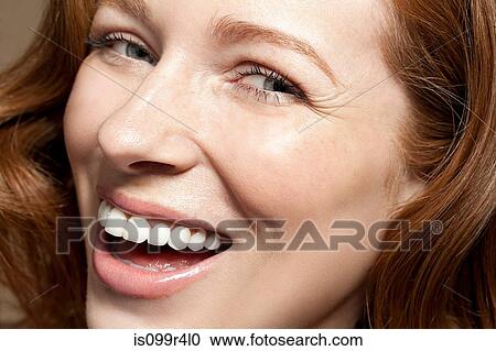 Woman looking at camera laughing, close up View Large Photo Image Stock Image - Woman looking at camera laughing, close up. Fotosearch