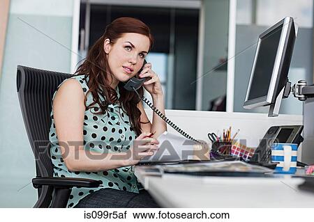 Stock Image - Woman on landline phone. Fotosearch