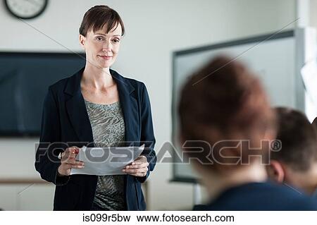 Woman presenting in meeting View Large Photo Image Stock Photo - Woman presenting in meeting. Fotosearch