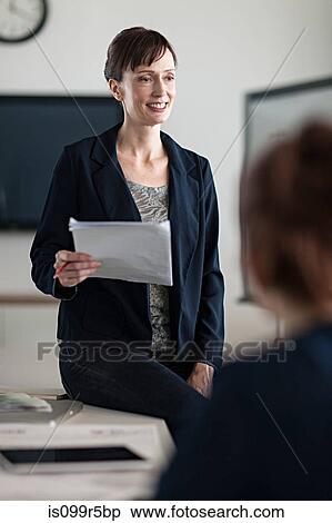 Stock Photography - Woman presenting in meeting. Fotosearch