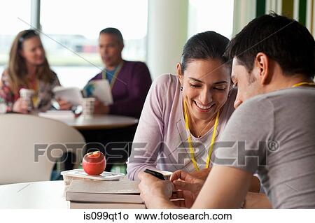 Picture - Woman showing man smartphone. Fotosearch