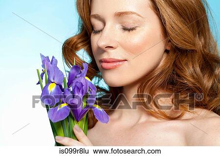 Woman smelling purple flowers View Large Photo Image Stock Photograph - Woman smelling purple flowers. Fotosearch