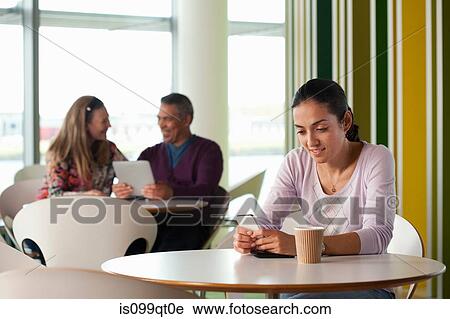 Stock Image - Woman texting on smartphone. Fotosearch