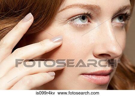 Woman touching face, close up View Large Photo Image Stock Photo - Woman touching face, close up. Fotosearch