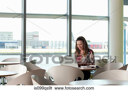 Woman using laptop in cafe View Large Photo Image Stock Photograph - Woman using laptop in cafe. Fotosearch