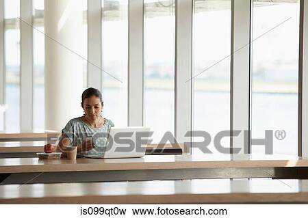 Woman using smartphone and laptop View Large Photo Image Stock Photo - Woman using smartphone and laptop. Fotosearch