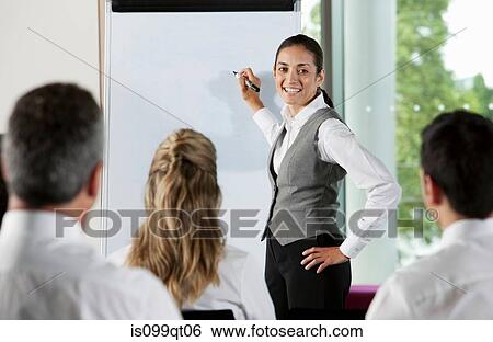Woman using whiteboard in business meeting View Large Photo Image Stock Photograph - Woman using whiteboard in business meeting. Fotosearch