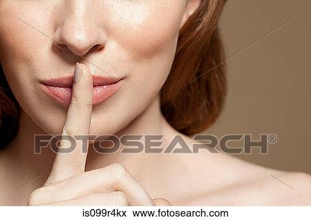 Woman with finger on lips, close up View Large Photo Image Stock Photo - Woman with finger on lips, close up. Fotosearch
