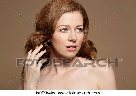Woman with hand in hair View Large Photo Image Stock Photograph - Woman with hand in hair. Fotosearch