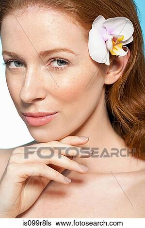 Stock Photograph - Woman with orchid in hair. Fotosearch