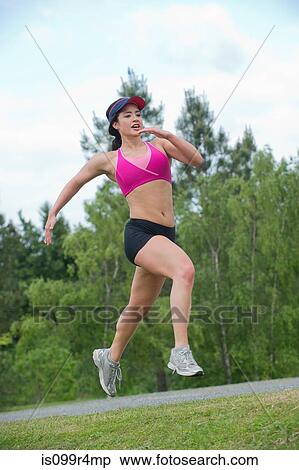 Young woman running in park View Large Photo Image Stock Photography - Young woman running in park. Fotosearch