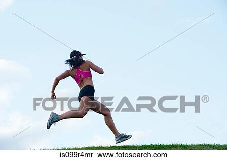 Stock Photography - Young woman running. Fotosearch