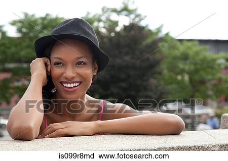 Stock Image - Young woman wearing a hat. Fotosearch
